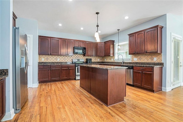 3641 Mountain Cove Rd, Snellville, GA 30039 - kitchen featuring stainless steel appliances, light wood-type flooring, backsplash, decorative light fixtures, and recessed lighting