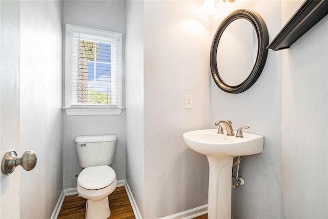 3641 Mountain Cove Rd, Snellville, GA 30039 - half bathroom with toilet, baseboards, and wood finished floors