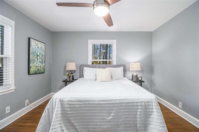 bedroom with ceiling fan, baseboards, and wood finished floors