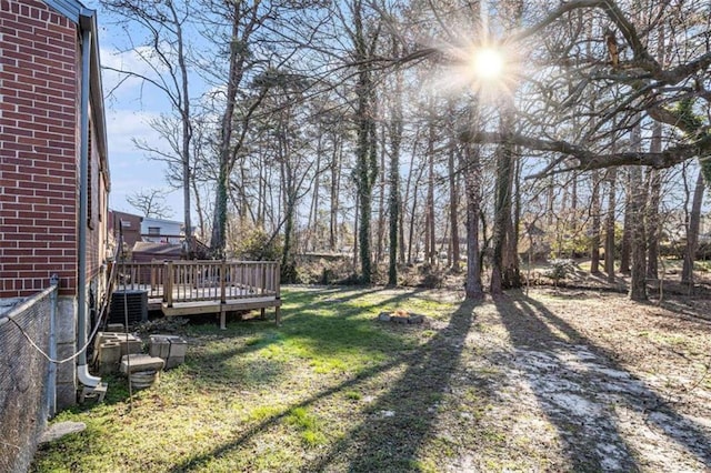 view of yard with a wooden deck and central AC unit