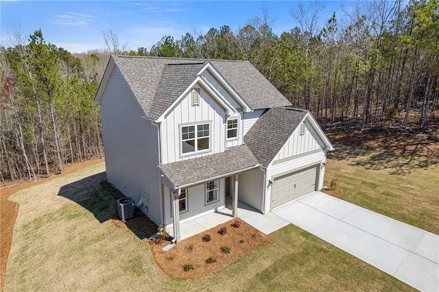 traditional home featuring a shingled roof, covered porch, and board and batten siding