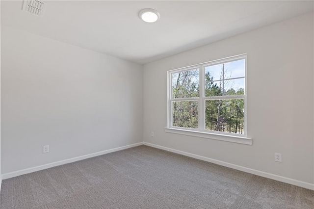 unfurnished room with baseboards and carpet
