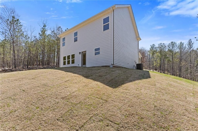 back of property featuring a lawn and cooling unit