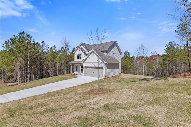 view of side of property featuring a lawn, an attached garage, concrete driveway, and a forest view