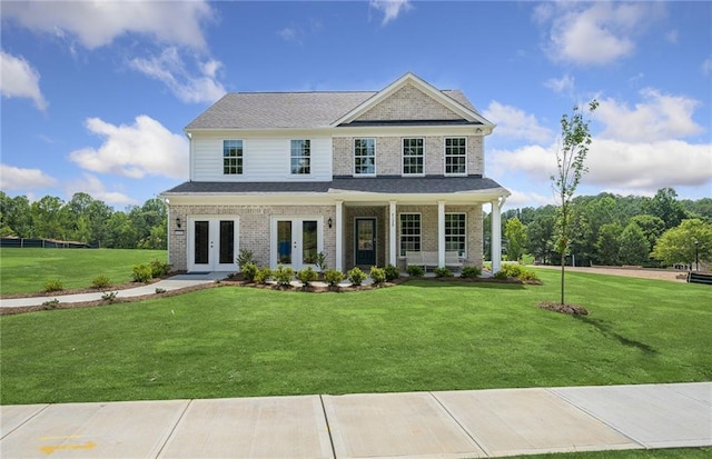 view of front facade with a front lawn and french doors