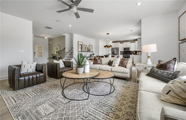 living room with ceiling fan and hardwood / wood-style floors