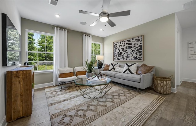 living room featuring ceiling fan and hardwood / wood-style floors