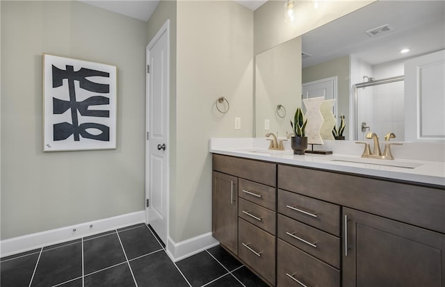 bathroom with tile patterned flooring, a shower with door, and vanity