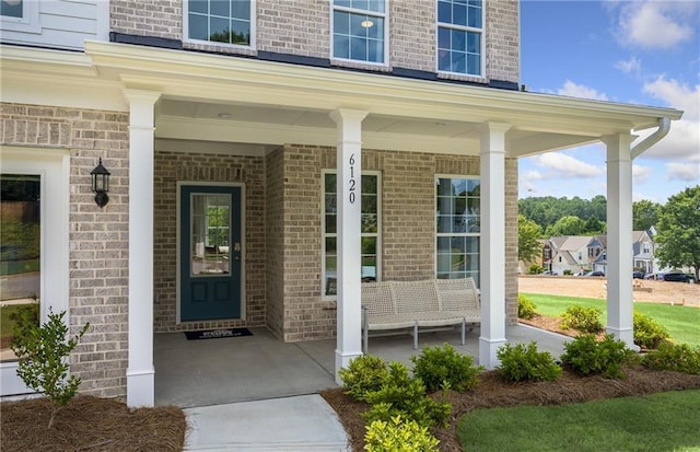 view of exterior entry featuring a porch