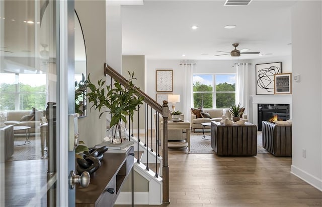 living room featuring ceiling fan and wood-type flooring