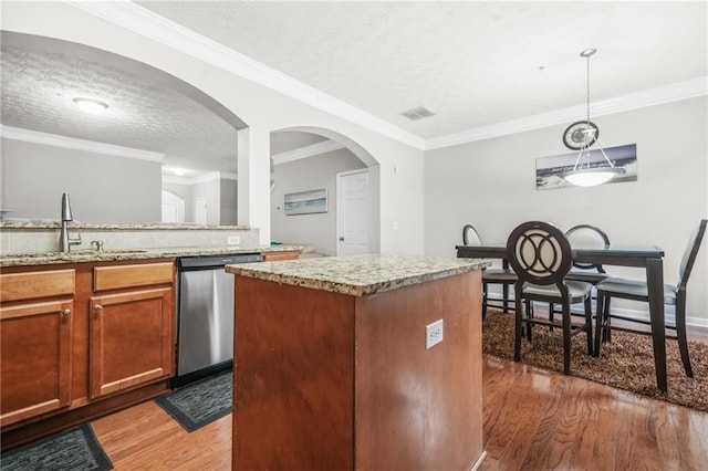 1622 Honeysuckle Path, Conyers, GA 30012 - kitchen with stainless steel dishwasher, a sink, light wood-style floors, a textured ceiling, and decorative light fixtures
