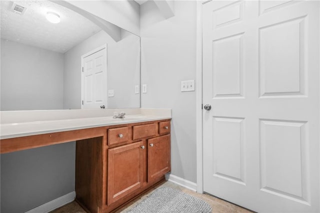 1622 Honeysuckle Path, Conyers, GA 30012 - bathroom with baseboards, vanity, and a textured ceiling