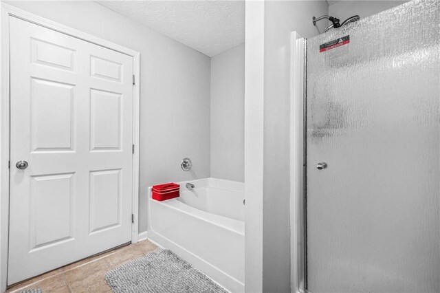 1622 Honeysuckle Path, Conyers, GA 30012 - bathroom featuring a bath, a shower stall, tile patterned flooring, and a textured ceiling