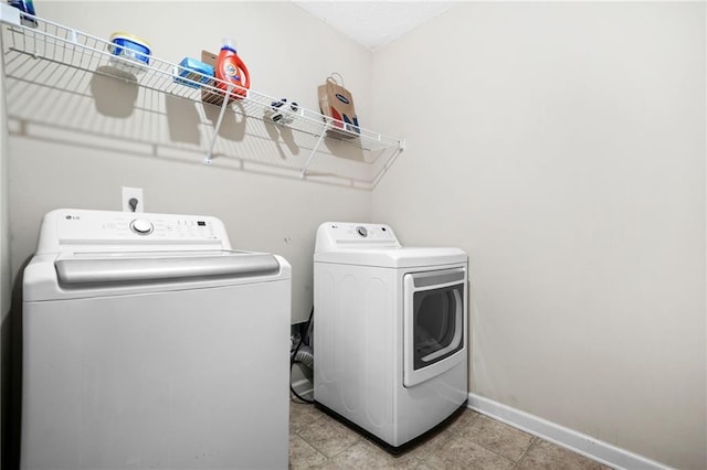 1622 Honeysuckle Path, Conyers, GA 30012 - laundry room featuring washing machine and dryer and baseboards