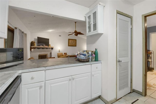 652 Post Oak Rd, Jonesboro, GA 30238 - kitchen with stainless steel microwave, dishwasher, ceiling fan, light countertops, and glass insert cabinets