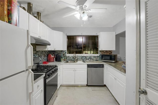 652 Post Oak Rd, Jonesboro, GA 30238 - kitchen with appliances with stainless steel finishes, under cabinet range hood, tasteful backsplash, and ceiling fan