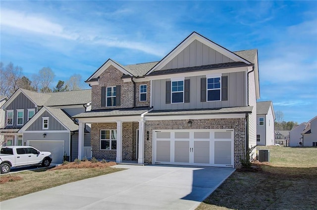 view of front of house featuring cooling unit, a garage, and a front lawn