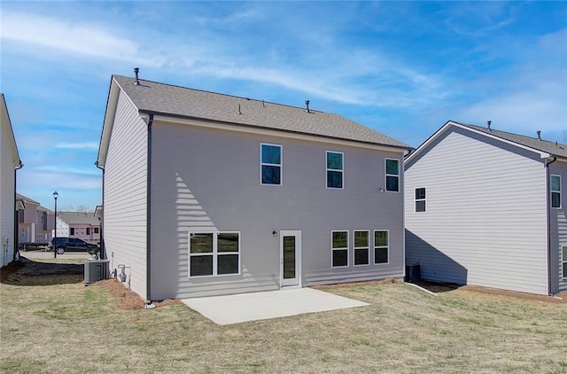 rear view of house with a yard, a patio area, and central air condition unit