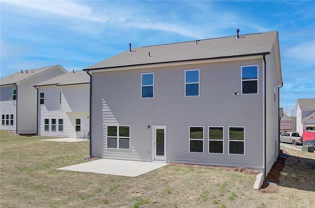 rear view of house featuring a patio area and a lawn