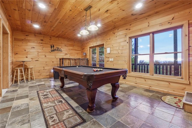 recreation room with wood ceiling, wood walls, dark tile flooring, and pool table