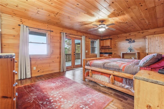 bedroom with french doors, access to exterior, wood-type flooring, wooden walls, and wood ceiling