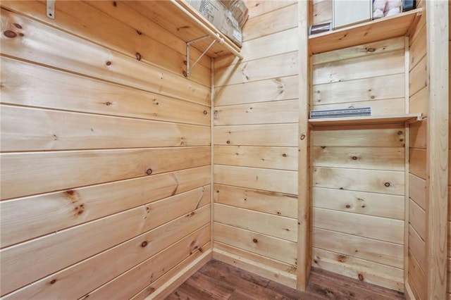 interior space with wooden walls and dark wood-type flooring