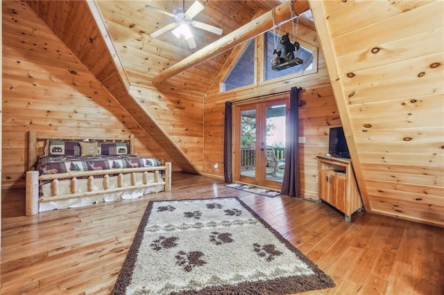 interior space featuring wood walls, wood-type flooring, french doors, wooden ceiling, and ceiling fan