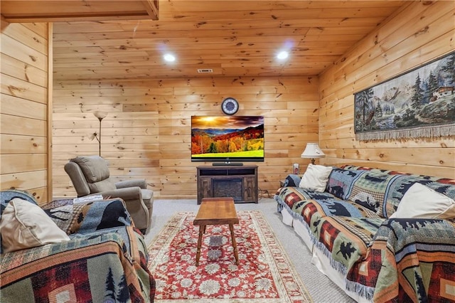 living room with wooden walls, light carpet, wooden ceiling, and a fireplace