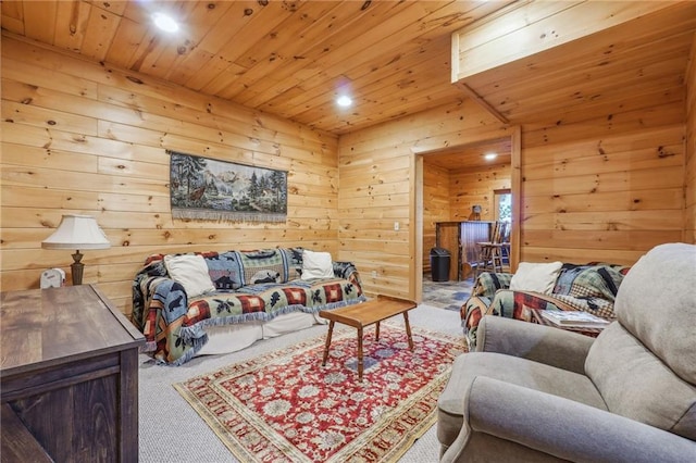 carpeted living room featuring wood ceiling and wooden walls