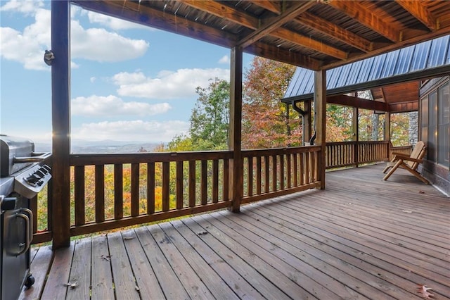 wooden terrace with a grill