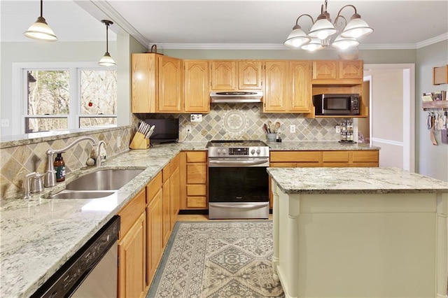 kitchen featuring sink, appliances with stainless steel finishes, a center island, light stone countertops, and decorative light fixtures