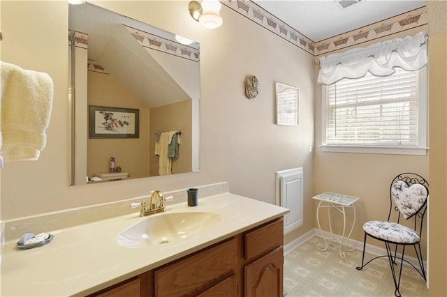 bathroom featuring vanity and toilet