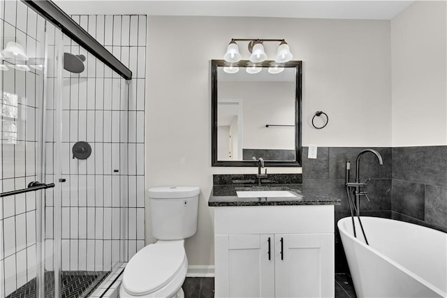 bathroom featuring vanity, toilet, and a tub