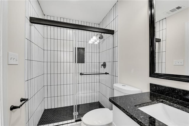 bathroom featuring walk in shower, vanity, and toilet