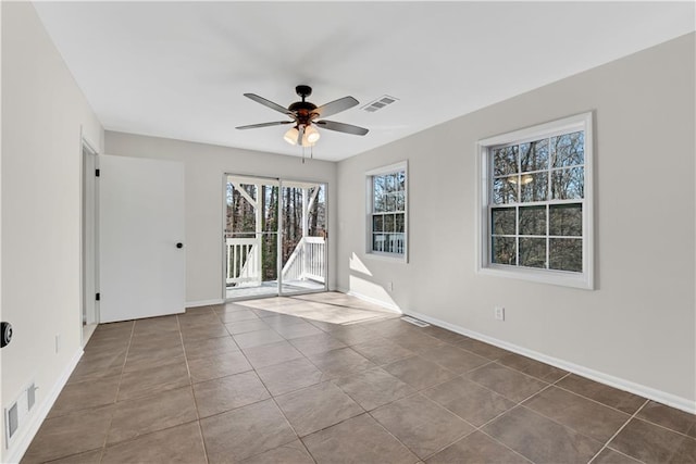 tiled spare room featuring ceiling fan