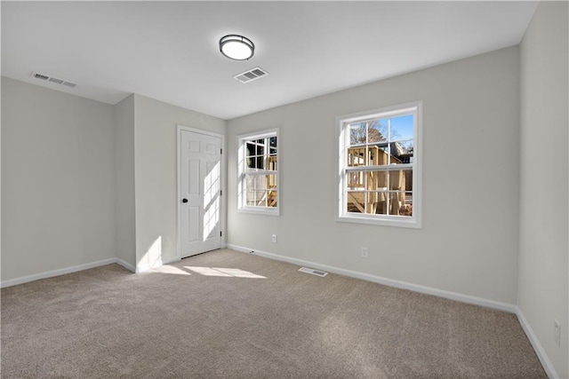 spare room with light colored carpet