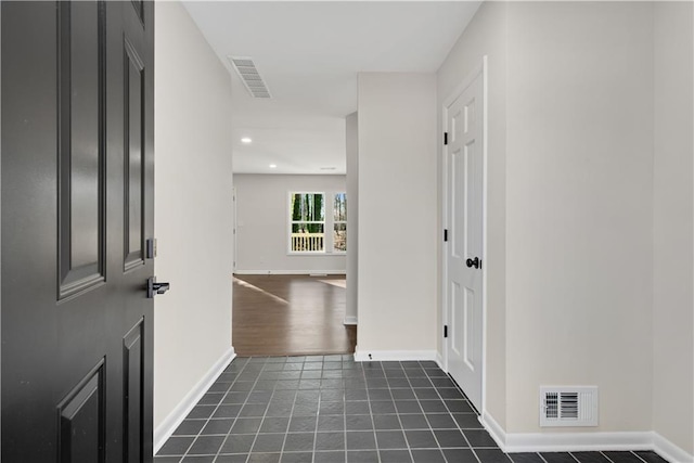 entrance foyer with dark tile patterned floors