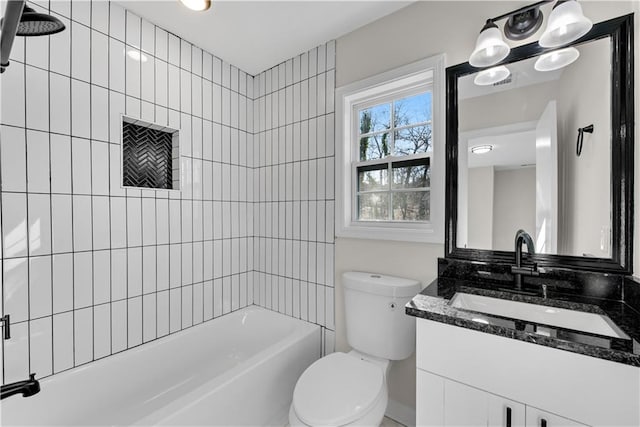 full bathroom with vanity, tiled shower / bath combo, and toilet