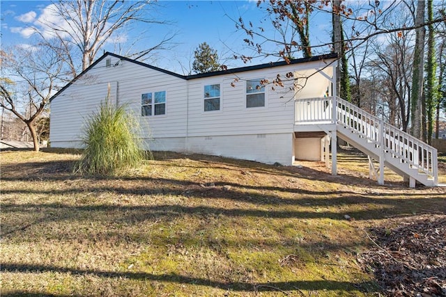 view of side of home with a lawn