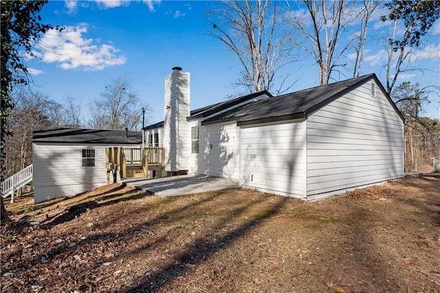 back of property featuring a patio area and a yard