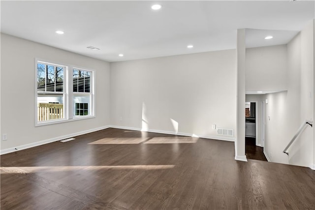 unfurnished living room featuring dark wood-type flooring