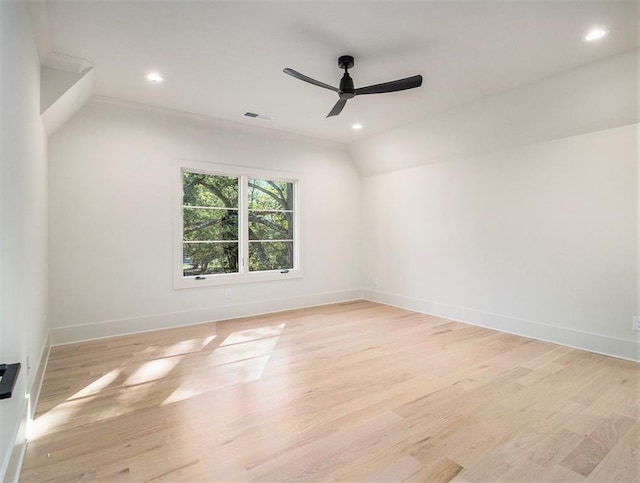 empty room with ceiling fan and light hardwood / wood-style floors