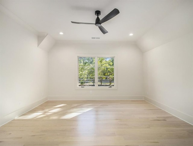 unfurnished room featuring light wood-type flooring, ornamental molding, vaulted ceiling, and ceiling fan