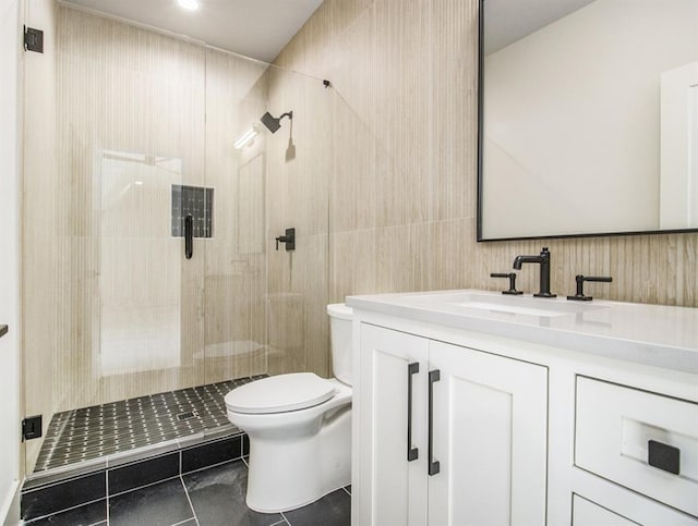 bathroom with walk in shower, vanity, toilet, and tile patterned floors