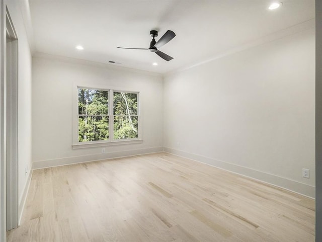 spare room with light wood-type flooring, crown molding, and ceiling fan