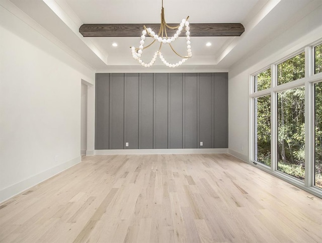 unfurnished room with a tray ceiling, a chandelier, light hardwood / wood-style floors, and beamed ceiling