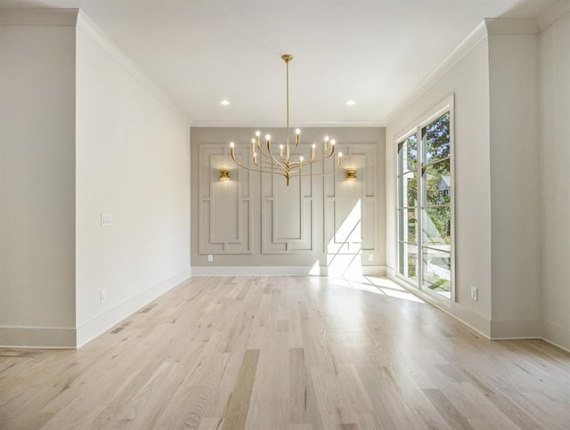 unfurnished dining area featuring an inviting chandelier, light hardwood / wood-style flooring, and crown molding