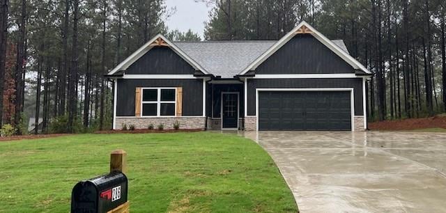 craftsman house with a front yard and a garage