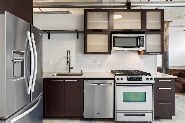 kitchen featuring sink, stainless steel appliances, dark brown cabinets, and tasteful backsplash