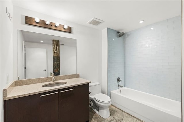 full bathroom with toilet, vanity, and tiled shower / bath